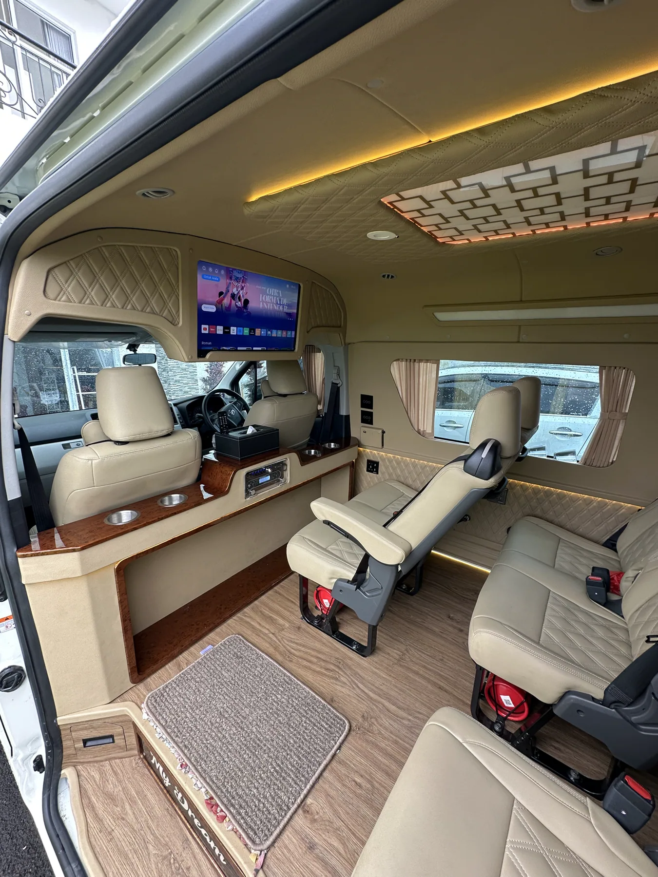 Area depan kabin Hiace Premio 2023 dengan TV Android dan console